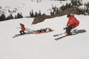 Ski patrollers assist an injured skier off the mountain.