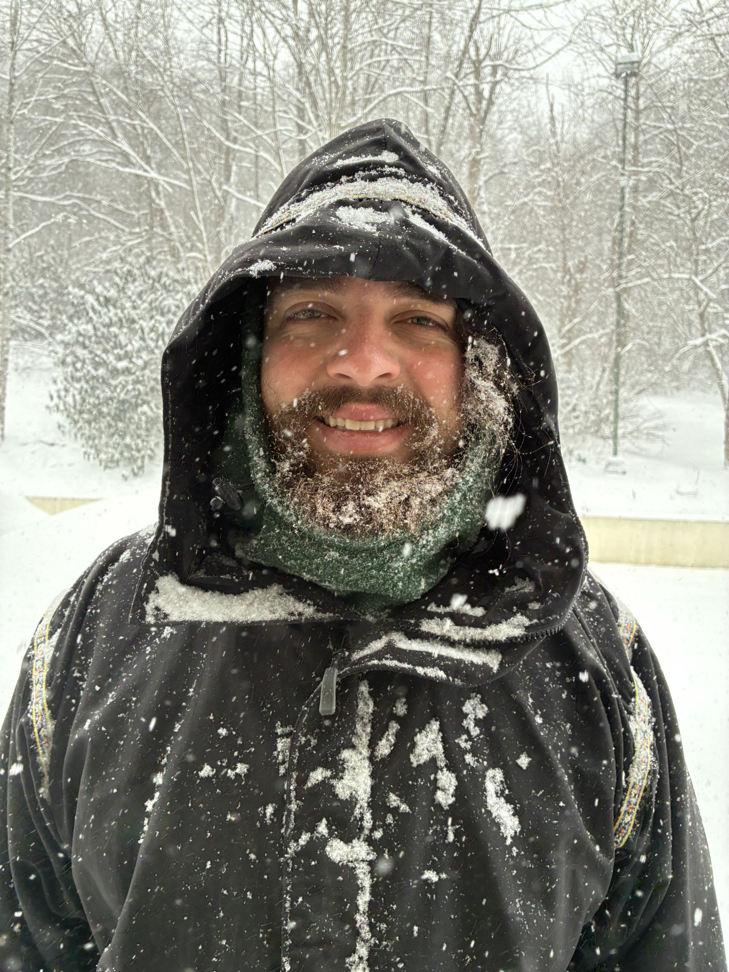 SOLO Manager Trey Walker smiles at the camera as light snow falls.
